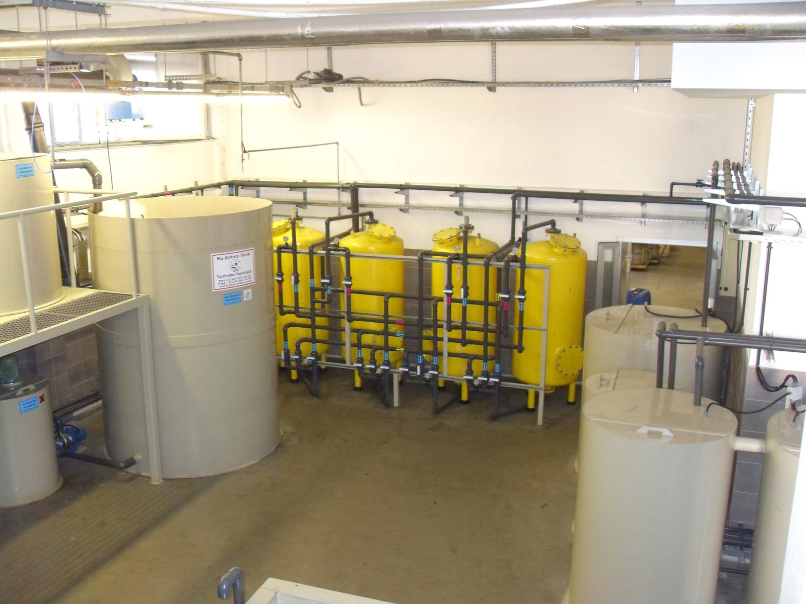 EJOT TEZMAK plant with 'This Treatment Plant Was Built by GESU' plate on a PP tank next to the yellow filter battery
